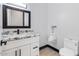 Modern bathroom with white vanity, granite countertop, and urinal at 6105 N 174Th Ave, Waddell, AZ 85355