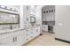 Double vanity bathroom with granite countertops and modern cabinetry at 6105 N 174Th Ave, Waddell, AZ 85355