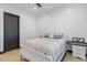 Light bedroom with white bed, wood floors, and modern door at 6105 N 174Th Ave, Waddell, AZ 85355