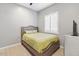 Comfortable bedroom with neutral decor and wood-look floors at 6105 N 174Th Ave, Waddell, AZ 85355