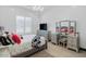 Charming bedroom with a vanity, tv, and window with plantation shutters at 6105 N 174Th Ave, Waddell, AZ 85355