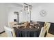 Elegant dining room with round table, stylish light fixture, and dark wood accents at 6105 N 174Th Ave, Waddell, AZ 85355