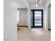 Bright and airy entryway with modern light fixture and sleek black door at 6105 N 174Th Ave, Waddell, AZ 85355