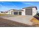 Exterior view of a beautiful modern home with a large garage at 6105 N 174Th Ave, Waddell, AZ 85355