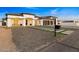 Modern home with three-car garage and landscaped front yard at 6105 N 174Th Ave, Waddell, AZ 85355