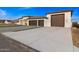 Modern home with three-car garage and landscaped entry at 6105 N 174Th Ave, Waddell, AZ 85355