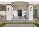 Covered entryway with gray tile flooring and modern lighting at 6105 N 174Th Ave, Waddell, AZ 85355