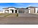 Stunning modern home with three-car garage and landscaped entry at 6105 N 174Th Ave, Waddell, AZ 85355