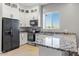 Modern kitchen with granite countertops and stainless steel appliances at 6105 N 174Th Ave, Waddell, AZ 85355