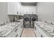 Laundry room offers ample counter space, modern appliances, and stylish cabinetry at 6105 N 174Th Ave, Waddell, AZ 85355