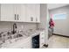 Laundry room with white cabinets and granite countertop at 6105 N 174Th Ave, Waddell, AZ 85355