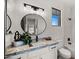 Modern bathroom with granite countertop, oval mirror and a soaking tub at 6268 S Martingale Ct, Gilbert, AZ 85298