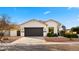 House exterior showcasing a modern design with dark garage door and landscaping at 6268 S Martingale Ct, Gilbert, AZ 85298