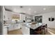 Modern kitchen with white cabinets, granite island, and stainless steel appliances at 6268 S Martingale Ct, Gilbert, AZ 85298