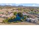 Aerial view of the community with a lake, lush landscaping, and nearby mountains at 7101 W Beardsley Rd # 942, Glendale, AZ 85308