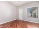 Hardwood floor bedroom with a window and door at 7101 W Beardsley Rd # 942, Glendale, AZ 85308