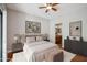 Cozy bedroom featuring a king-size bed, soft lighting, and ensuite bathroom access at 7101 W Beardsley Rd # 942, Glendale, AZ 85308