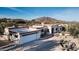 Aerial view of a single-story home with a large driveway and desert landscaping at 7957 E Cave Creek Rd, Carefree, AZ 85377