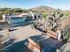 Aerial view of a single-story home with a large driveway and desert landscaping at 7957 E Cave Creek Rd, Carefree, AZ 85377