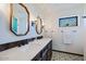 Double vanity bathroom with octagonal mirrors and patterned tile floor at 7957 E Cave Creek Rd, Carefree, AZ 85377