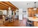 Wood beams, round dining table, and adjacent kitchen at 7957 E Cave Creek Rd, Carefree, AZ 85377