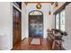 Entryway with tiled floor, wooden bench, and double doors at 7957 E Cave Creek Rd, Carefree, AZ 85377