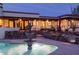 House exterior with pool and fountain at night at 7957 E Cave Creek Rd, Carefree, AZ 85377