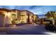 Evening view of a Spanish-style home with exterior lighting and landscaping at 7957 E Cave Creek Rd, Carefree, AZ 85377