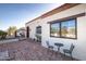 Side view of a Spanish-style home with brick patio and landscaping at 7957 E Cave Creek Rd, Carefree, AZ 85377