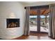 Fireplace with wood mantle and access to private patio through French doors at 7957 E Cave Creek Rd, Carefree, AZ 85377