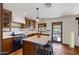 Rustic kitchen with wood cabinets, island, and tiled flooring at 7957 E Cave Creek Rd, Carefree, AZ 85377