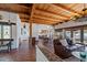 Open living room features wood beams, tile floors, and a charming southwestern aesthetic at 7957 E Cave Creek Rd, Carefree, AZ 85377