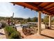 Landscaped pool area with fountain and patio seating at 7957 E Cave Creek Rd, Carefree, AZ 85377