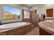 Bathroom with large soaking tub, walk-in shower, and a view at 8137 N 13Th Pl, Phoenix, AZ 85020