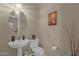 Elegant powder room with pedestal sink and decorative accents at 8137 N 13Th Pl, Phoenix, AZ 85020