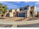 Two-story home with a teal garage door and desert landscaping at 8137 N 13Th Pl, Phoenix, AZ 85020