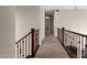 Upstairs hallway with wood railing and carpeted flooring at 8137 N 13Th Pl, Phoenix, AZ 85020