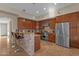 Kitchen with an island, wood cabinets, and stainless steel appliances at 8137 N 13Th Pl, Phoenix, AZ 85020