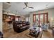 Open living room and kitchen with a brown leather sofa at 8137 N 13Th Pl, Phoenix, AZ 85020