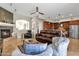 Open living room with a fireplace, kitchen island, and access to a patio at 8137 N 13Th Pl, Phoenix, AZ 85020