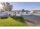 House backyard with covered patio and grassy area at 8230 W Monterey Way, Phoenix, AZ 85033