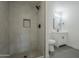 Updated bathroom with walk-in shower, modern vanity, and gray tile at 8230 W Monterey Way, Phoenix, AZ 85033