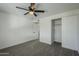 Bright bedroom with ceiling fan and ample closet space at 8230 W Monterey Way, Phoenix, AZ 85033