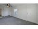 Spacious bedroom with ceiling fan, carpet, and ample closet space at 8230 W Monterey Way, Phoenix, AZ 85033