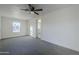 Well-lit bedroom with ceiling fan, carpet, and window at 8230 W Monterey Way, Phoenix, AZ 85033