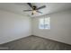 Bright bedroom with ceiling fan and carpet at 8230 W Monterey Way, Phoenix, AZ 85033