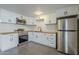 Updated kitchen featuring white cabinets and wood countertops at 8230 W Monterey Way, Phoenix, AZ 85033