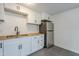 Modern kitchen with white cabinets, butcher block countertops, and stainless steel appliances at 8230 W Monterey Way, Phoenix, AZ 85033