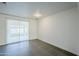 Kitchen featuring white cabinets, gray tile floors, and a sliding glass door at 8230 W Monterey Way, Phoenix, AZ 85033