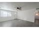 Living room with gray tile floors, a ceiling fan, and white walls at 8230 W Monterey Way, Phoenix, AZ 85033